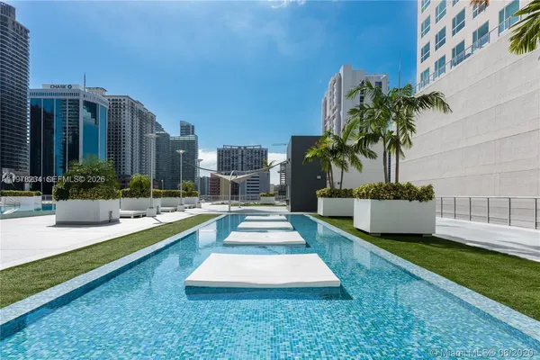 a swimming pool with outdoor seating and yard