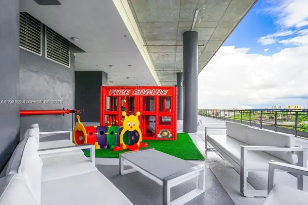a backyard of a house with barbeque oven table and chairs
