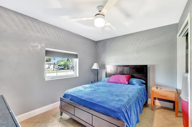 a bedroom with a bed and a lamp