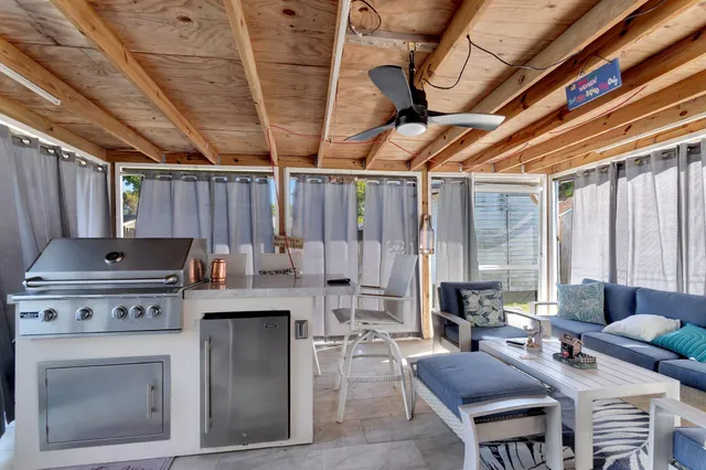 a open kitchen with a stove a table and chairs