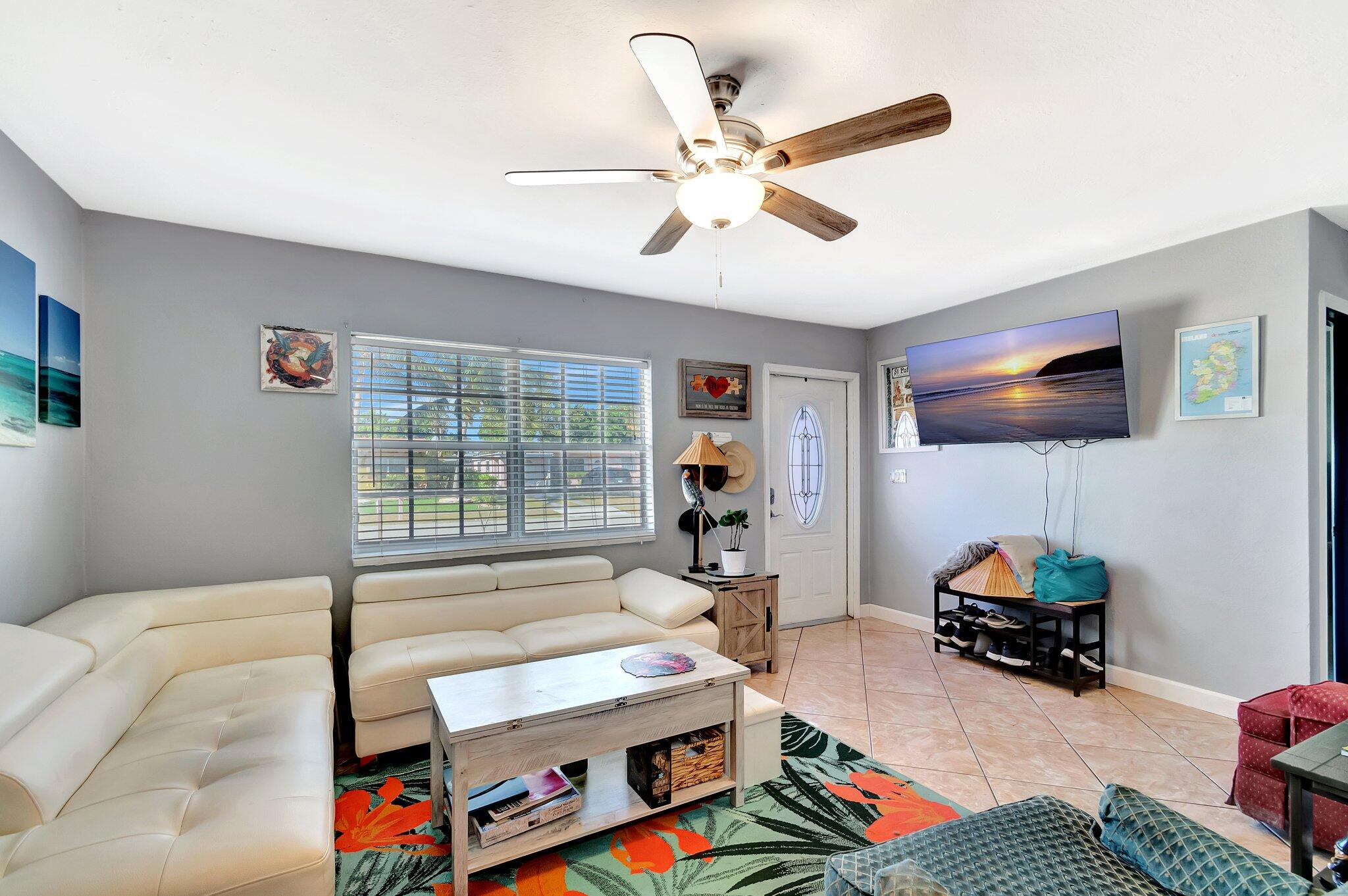 3890 Ocala Road Lake Worth, FL 33462 - Photo 2 of 29 a living room with furniture and a flat screen tv