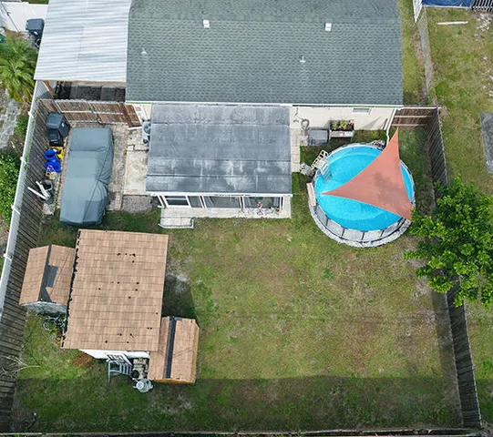 an aerial view of a house with a swimming pool