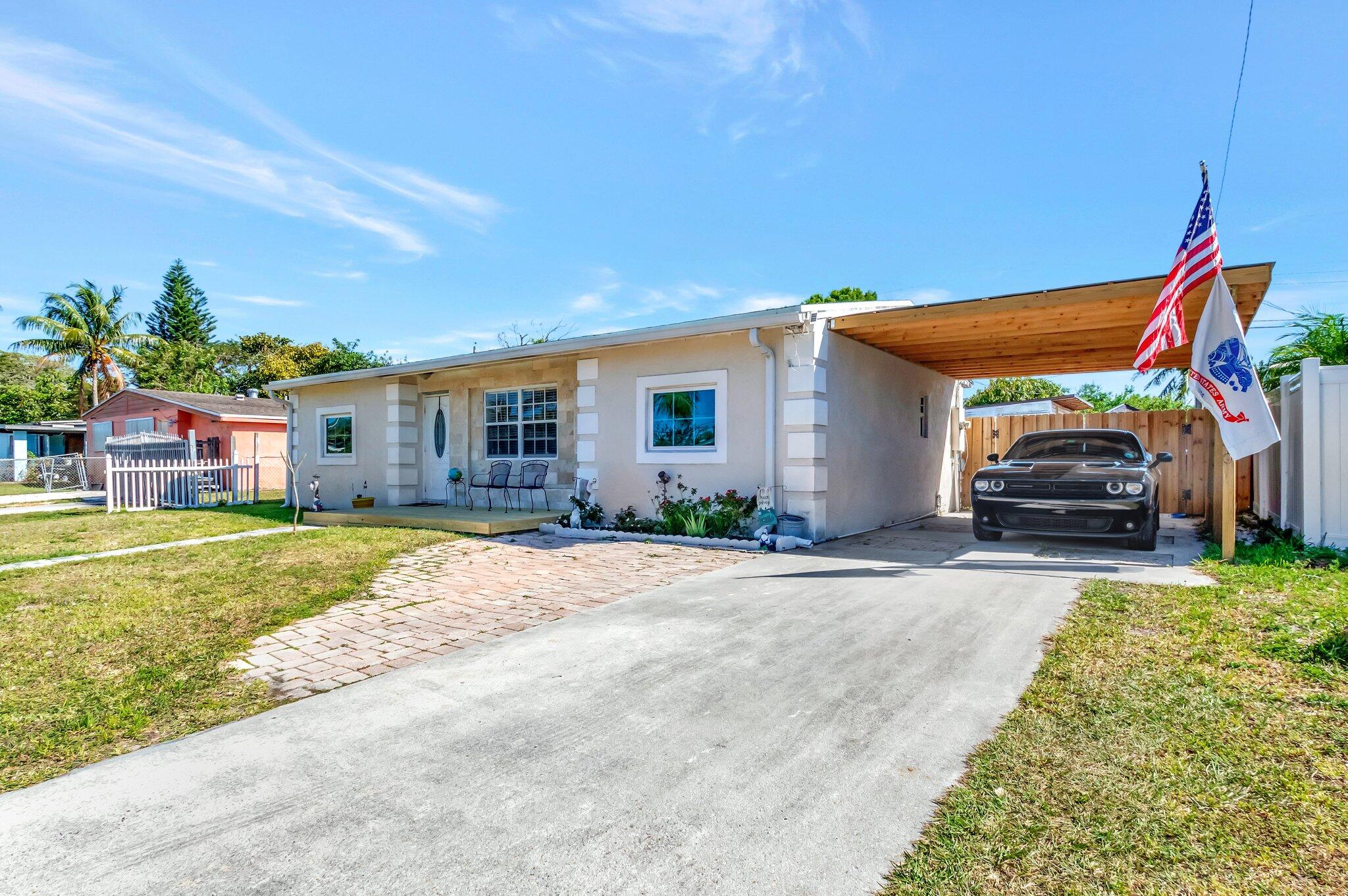 3890 Ocala Road Lake Worth, FL 33462 - Photo 5 of 29 a house view with a garden space