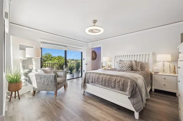 a bedroom with a large bed and a flat tv screen on dresser