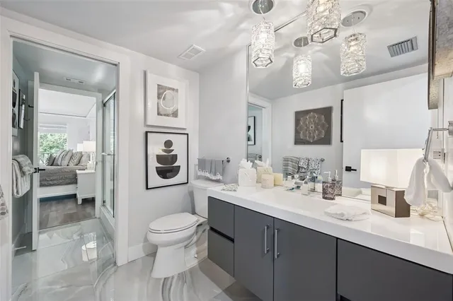 a white toilet sitting next to a bathroom sink