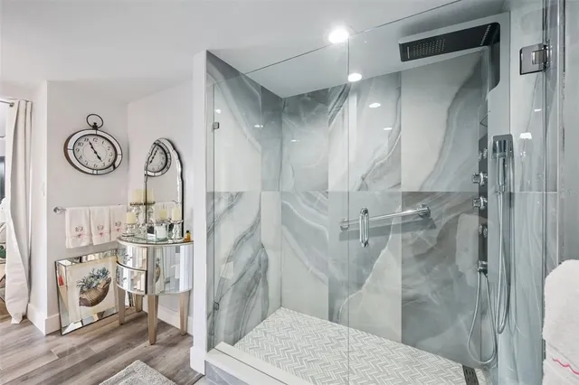 a bathroom with a glass shower door