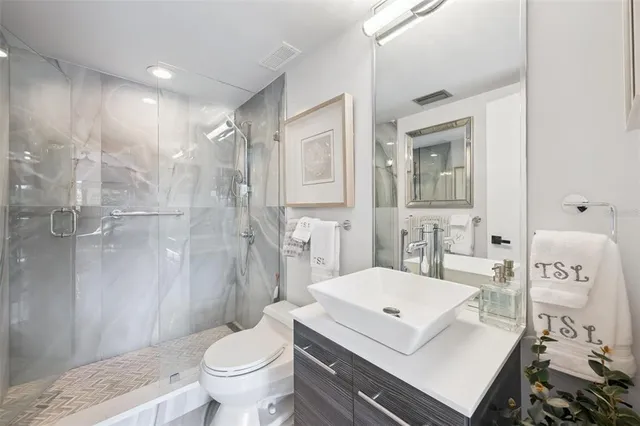 a view of a walk in closet and bathroom