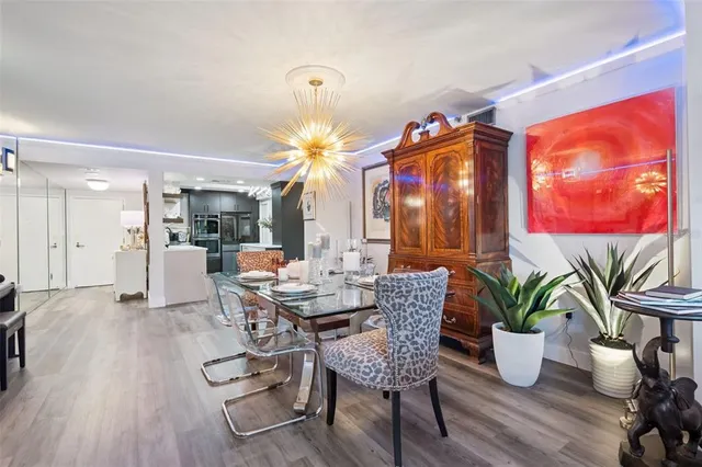 a view of a dining room with furniture and wooden floor