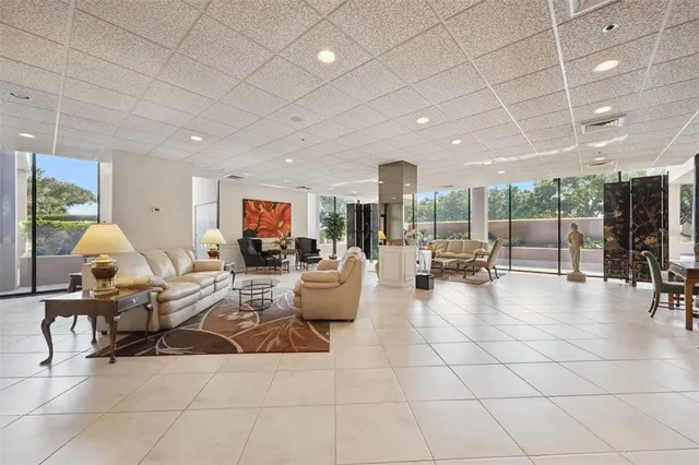 a living room with patio furniture and a large window