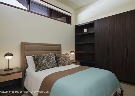 a bedroom with a bed and a night stand