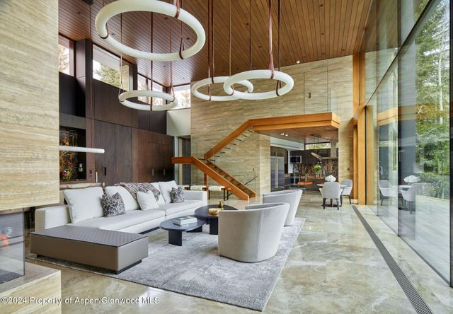 a living room with couches a dining table and chairs