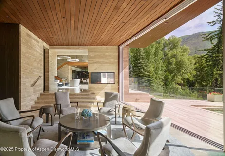 a view of a dining room with furniture window and outside view