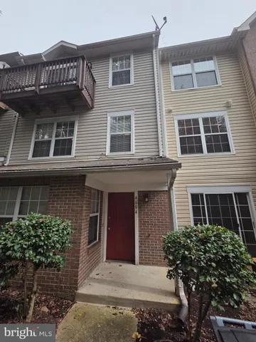a view of a brick house with large windows