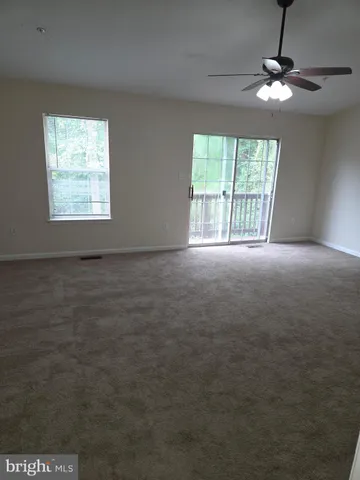 a view of a chandelier fan in a room