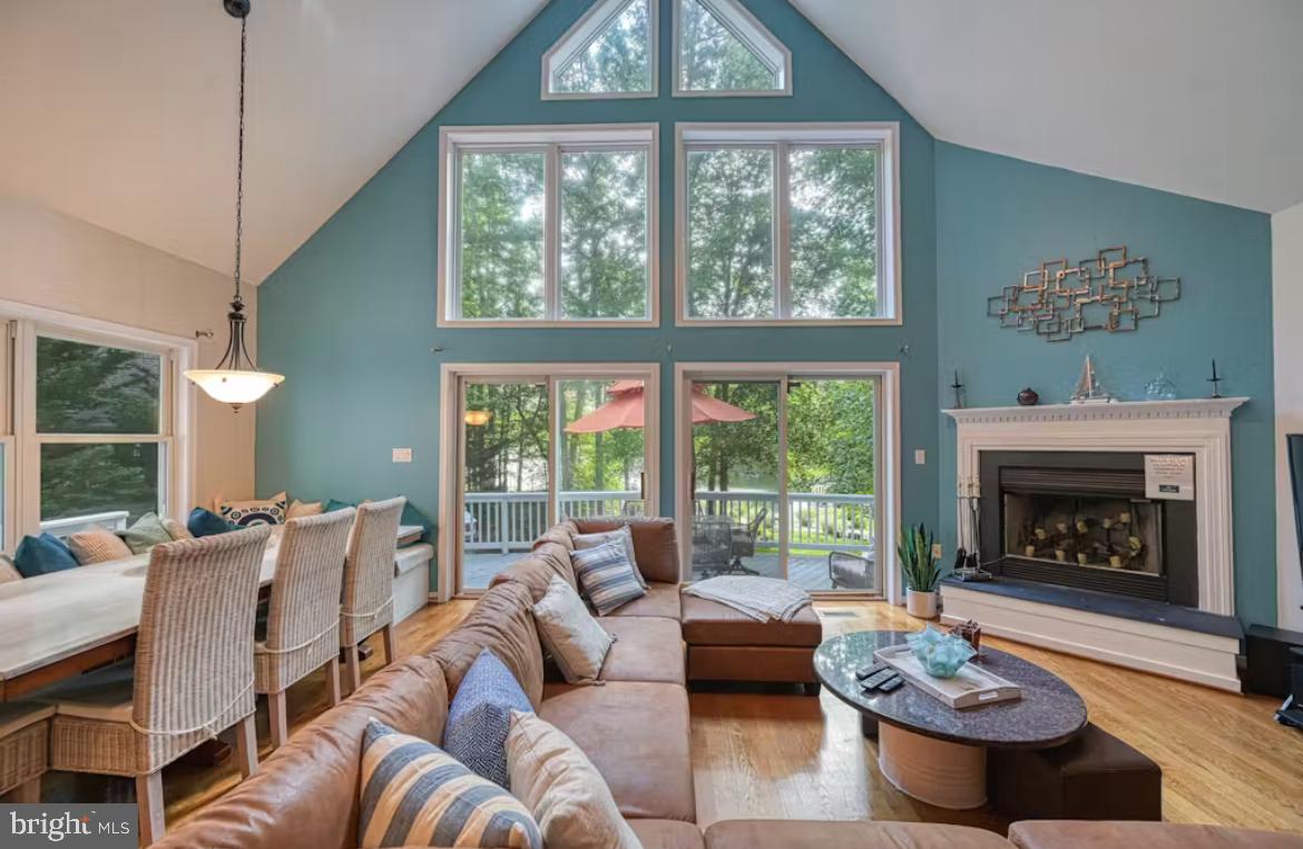 a living room with furniture a fireplace and a large window