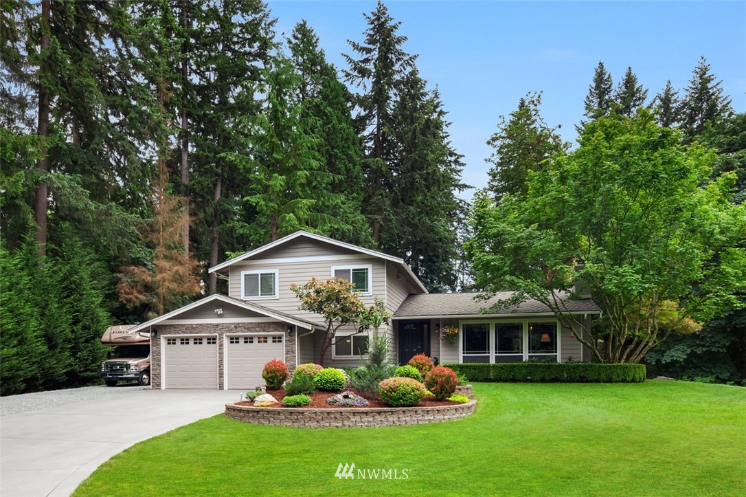 22303 49th Avenue Southeast Bothell, WA 98021 - Photo 1 of 25 a front view of a house with garden