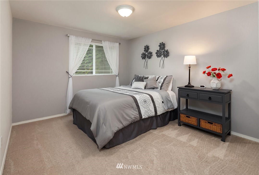 22303 49th Avenue Southeast Bothell, WA 98021 - Photo 12 of 25 a bedroom with a bed and a window