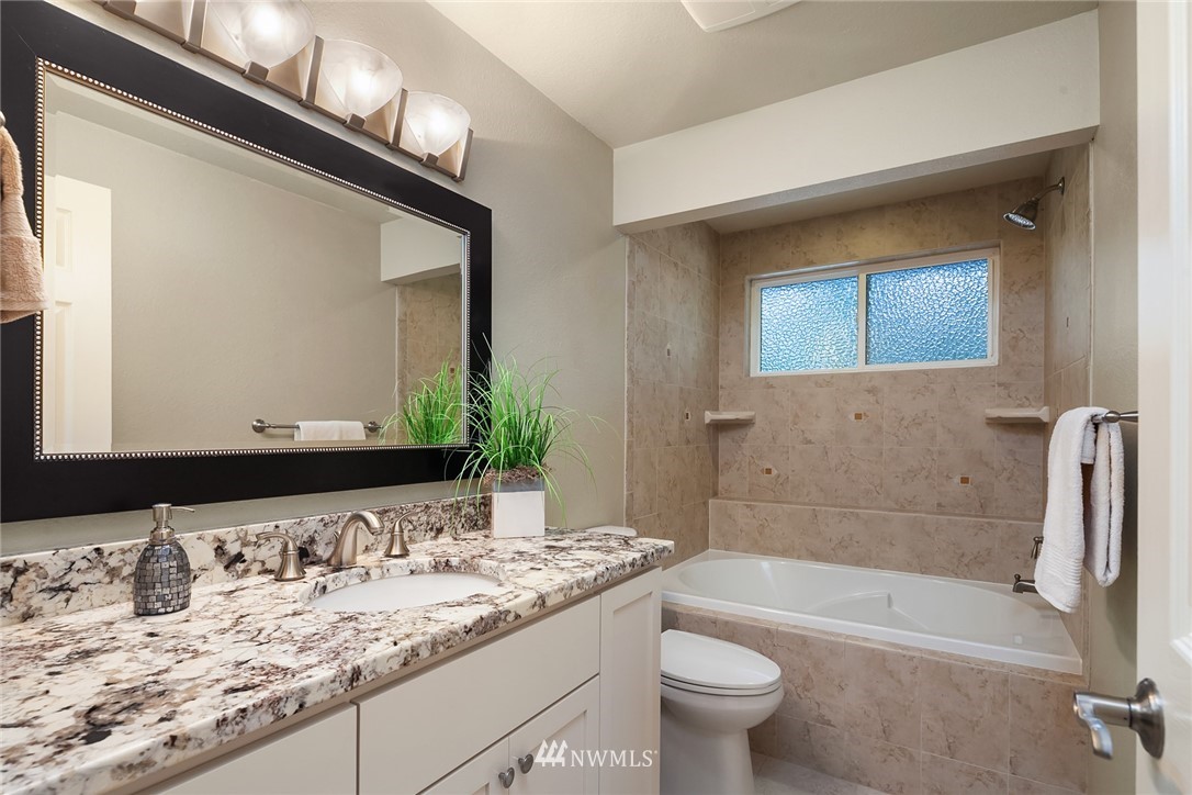 22303 49th Avenue Southeast Bothell, WA 98021 - Photo 13 of 25 a bathroom with a granite countertop sink a toilet and a bathtub