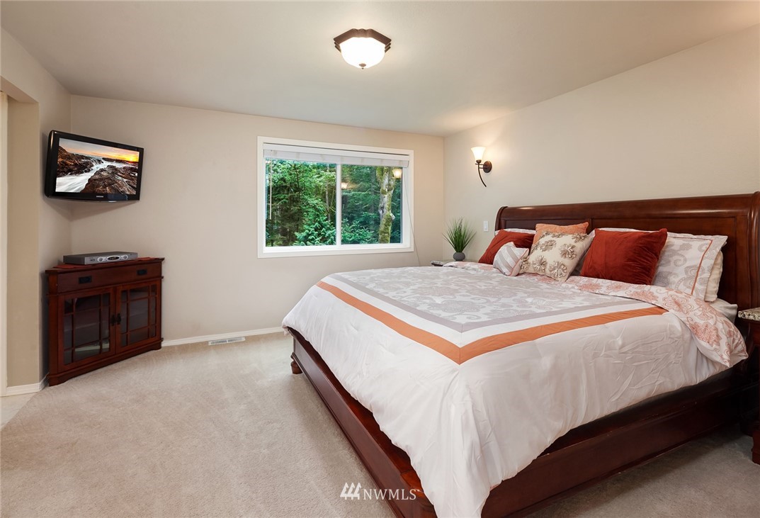 22303 49th Avenue Southeast Bothell, WA 98021 - Photo 14 of 25 a bedroom with a bed and a television