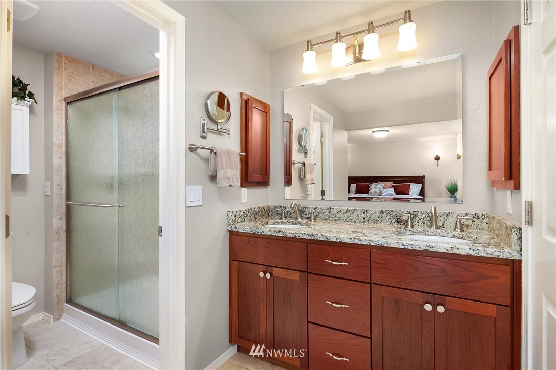 22303 49th Avenue Southeast Bothell, WA 98021 - Photo 15 of 25 a bathroom with a granite countertop sink and a mirror