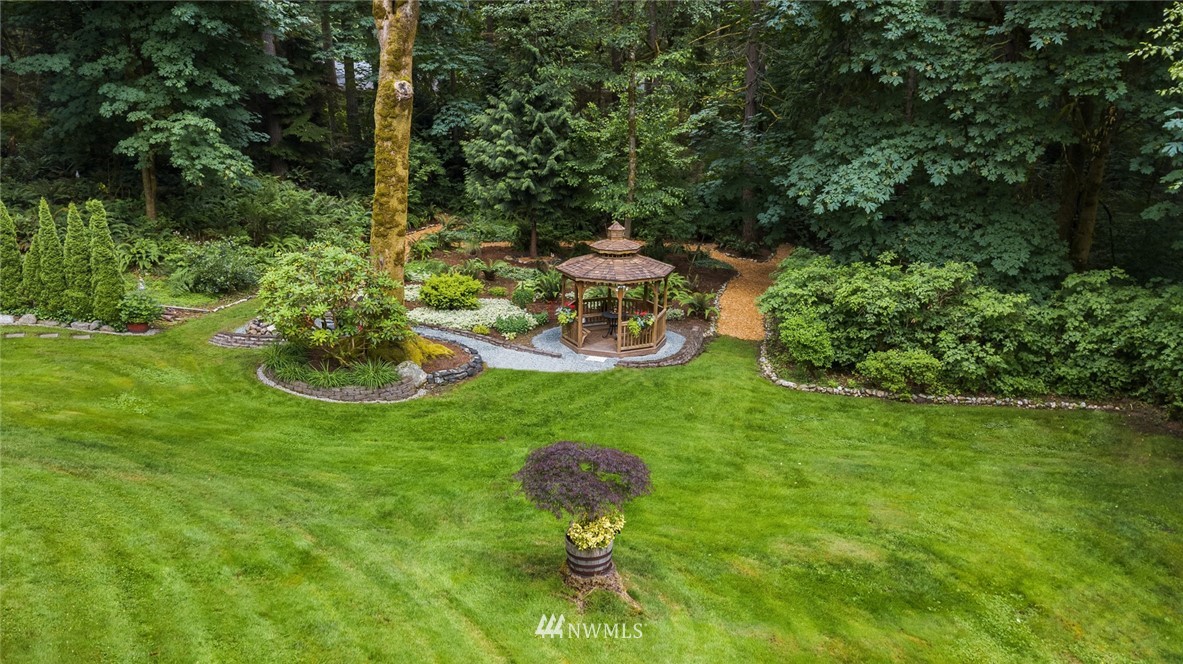 22303 49th Avenue Southeast Bothell, WA 98021 - Photo 3 of 25 a view of a table and chairs in the garden