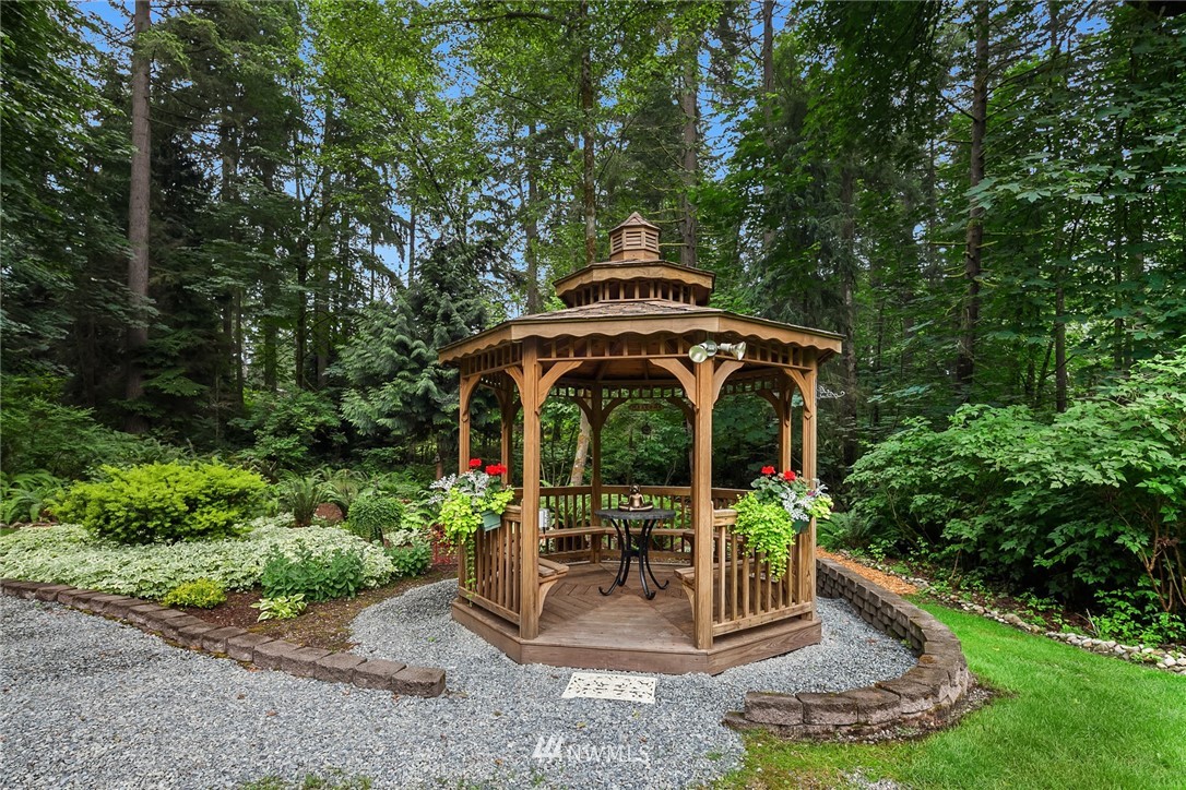 22303 49th Avenue Southeast Bothell, WA 98021 - Photo 22 of 25 a front view of a house with garden