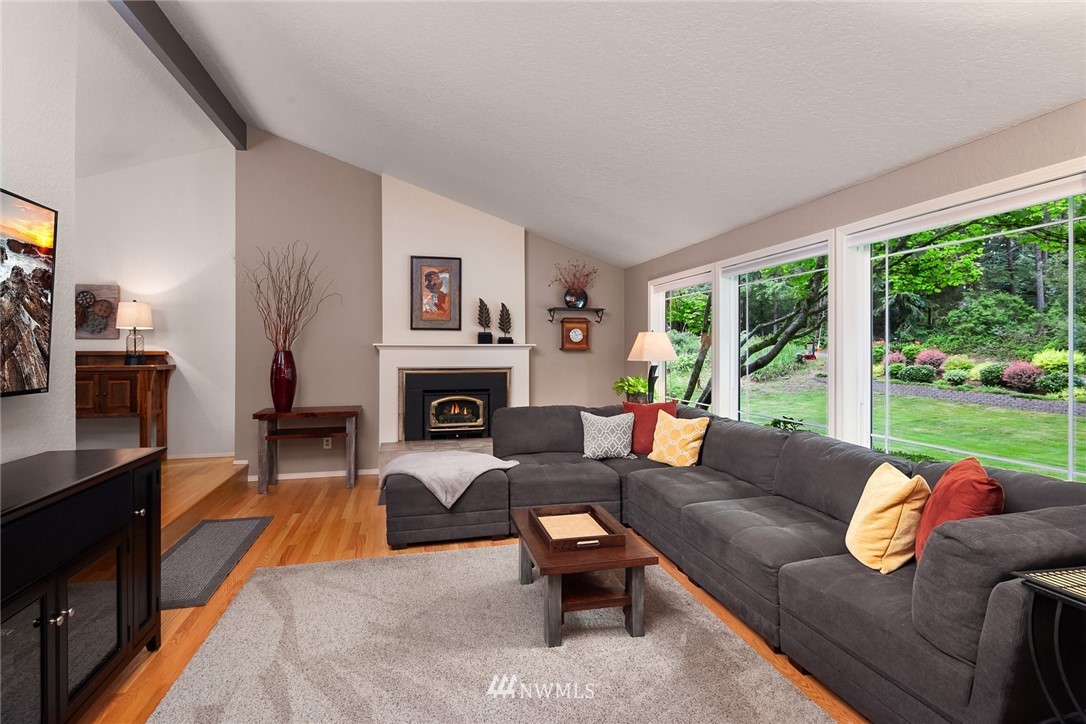 22303 49th Avenue Southeast Bothell, WA 98021 - Photo 4 of 25 a living room with furniture a large window and a fireplace