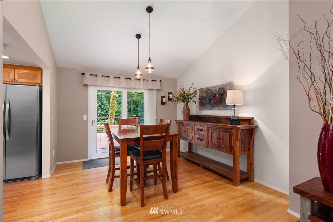 22303 49th Avenue Southeast Bothell, WA 98021 - Photo 7 of 25 a dining room with furniture a chandelier and wooden floor