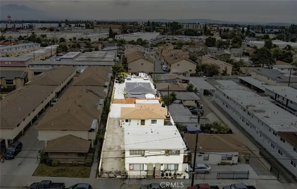 an aerial view of residential houses with outdoor space