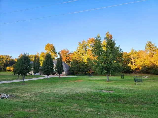 a view of a field with trees in background