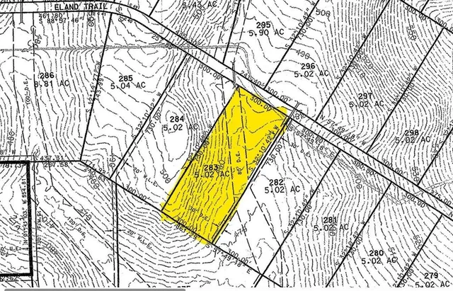 a view of a park with large trees