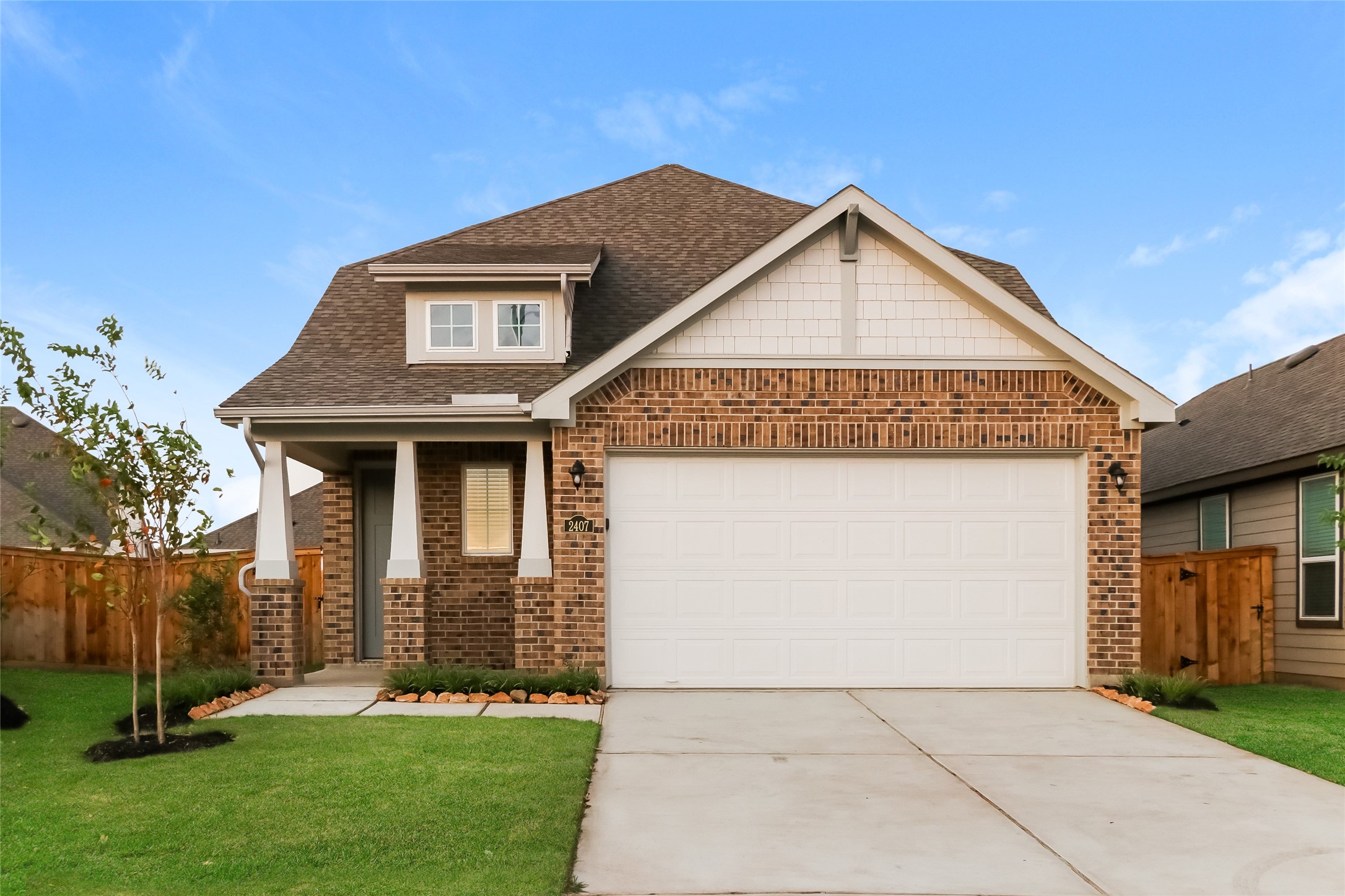 a front view of a house with a yard and garage