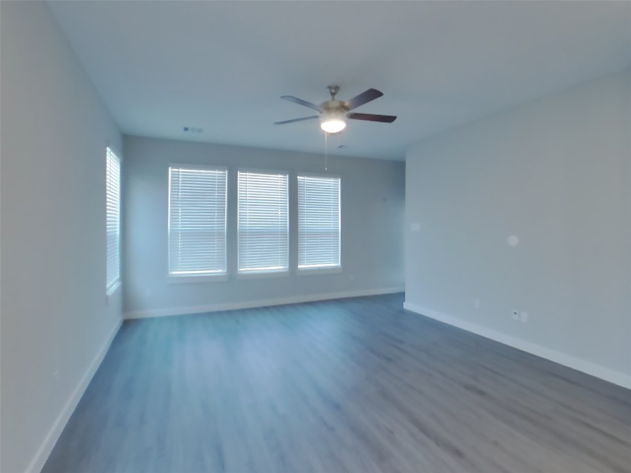 2407 Foster Hl Road Richmond, TX 77469 - Photo 2 of 24 a view of empty room with wooden floor and fan