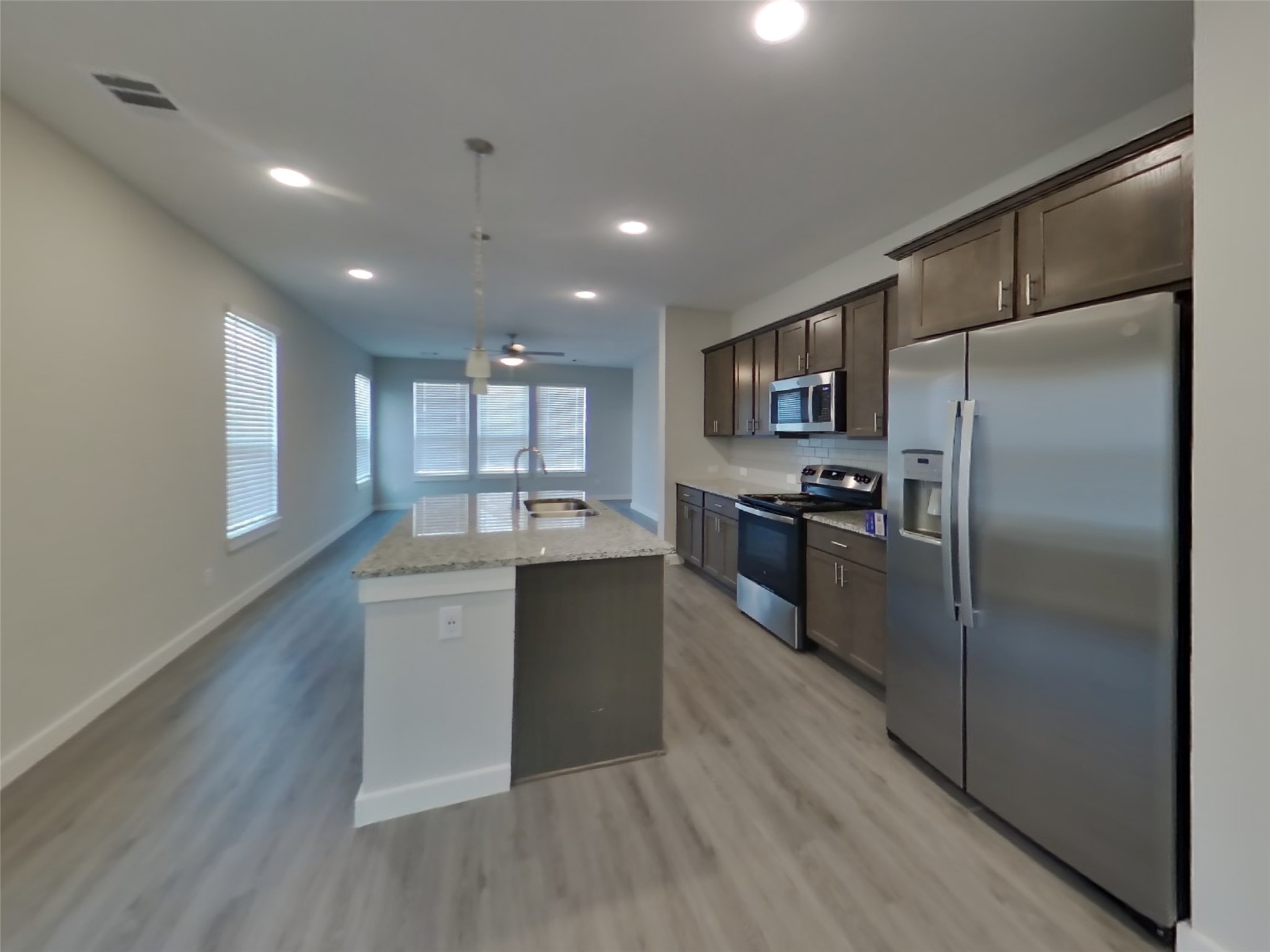 2407 Foster Hl Road Richmond, TX 77469 - Photo 6 of 24 a kitchen with kitchen island stainless steel appliances sink refrigerator and microwave