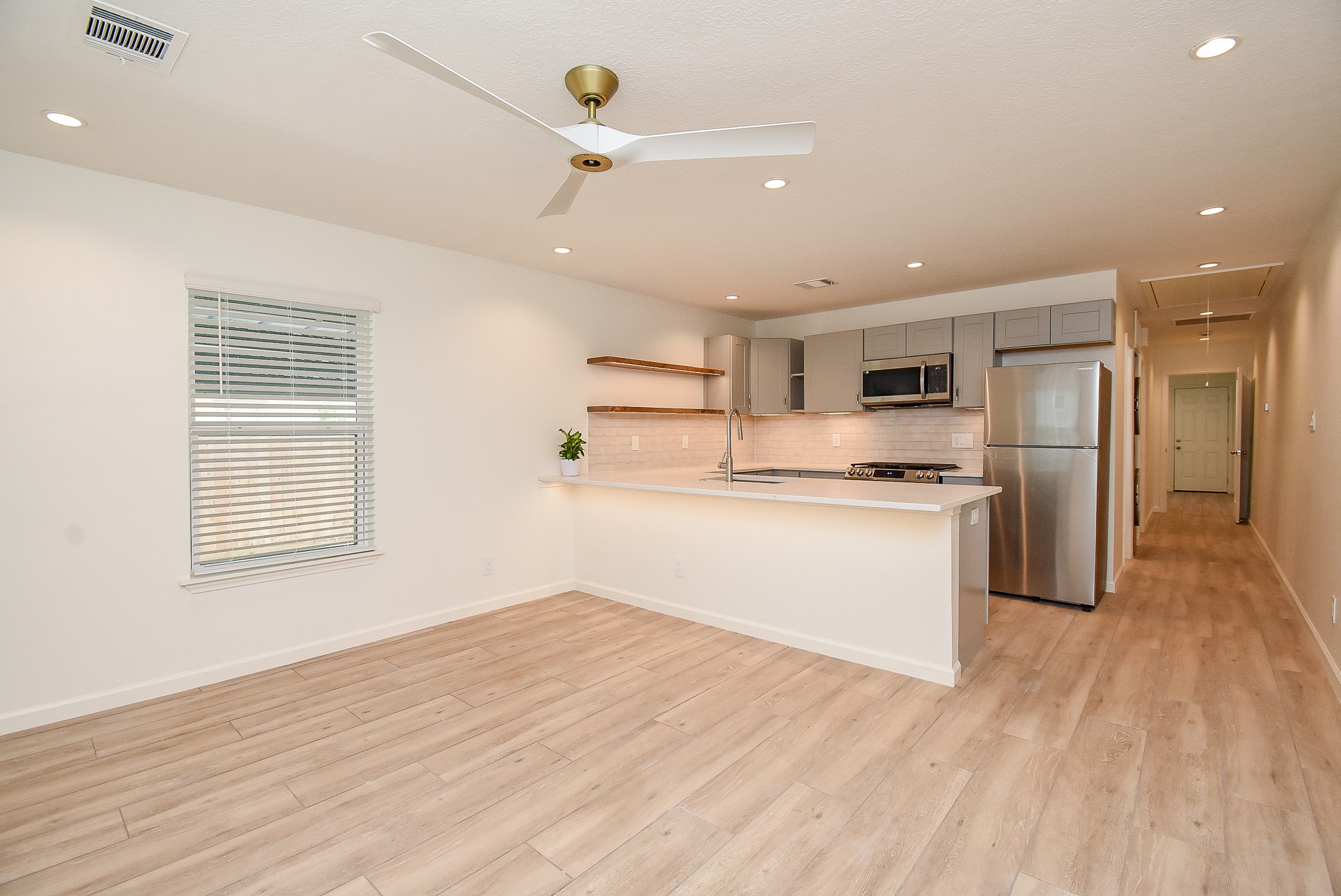 2509 Terry Street, Unit A Houston, TX 77009 - Photo 11 of 22 a kitchen with refrigerator cabinets and wooden floor