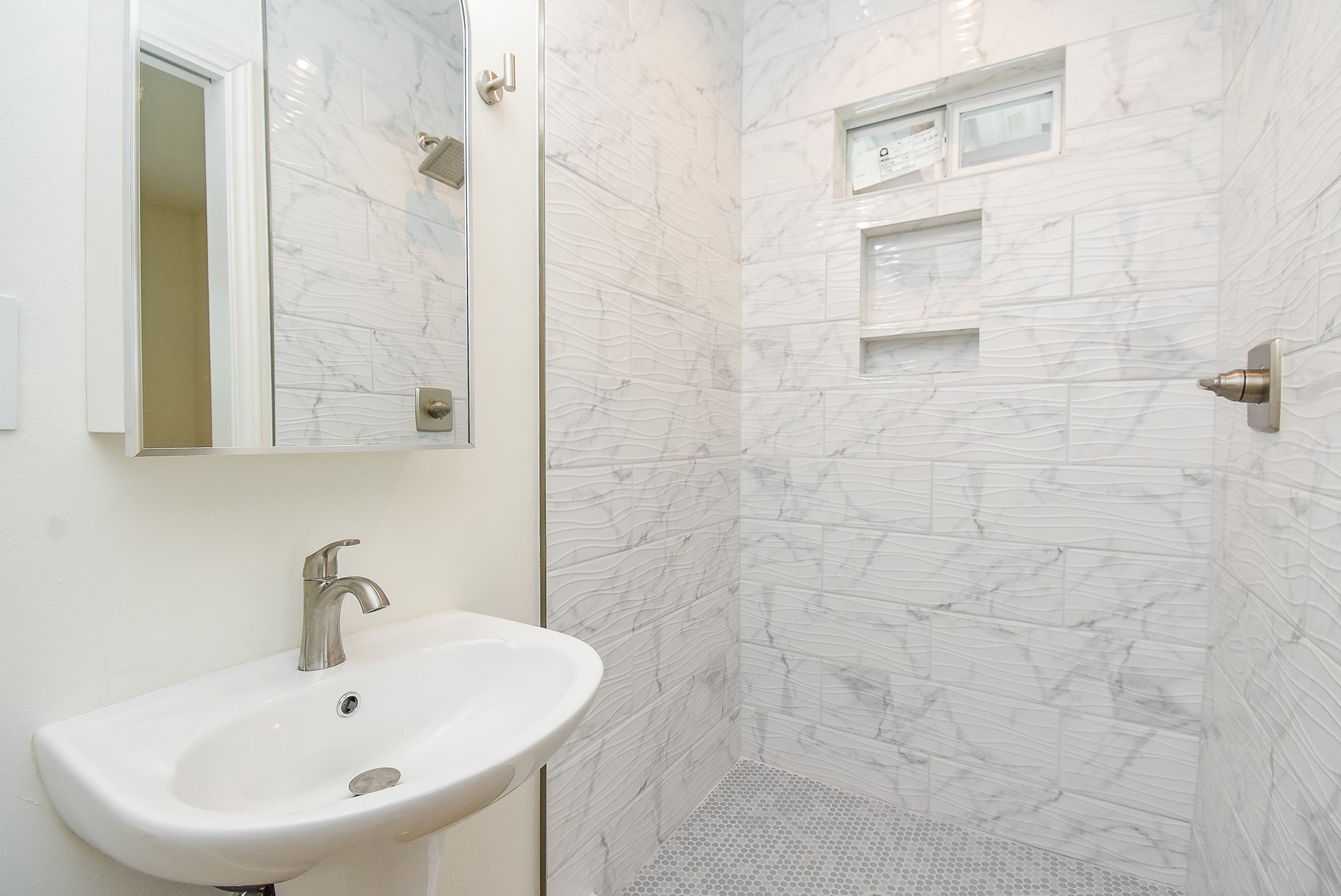 2509 Terry Street, Unit A Houston, TX 77009 - Photo 22 of 22 a bathroom with a sink a shower and a mirror