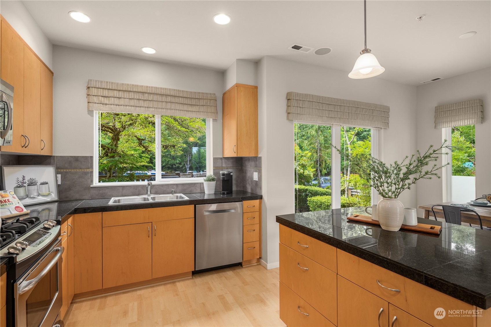 145 Sky Ridge Road Northwest Issaquah, WA 98027 - Photo 6 of 36 a kitchen with large windows sink and cabinets
