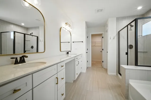 a spacious bathroom with a double vanity sink mirror and double
