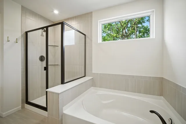 a bathroom with a bathtub and a shower