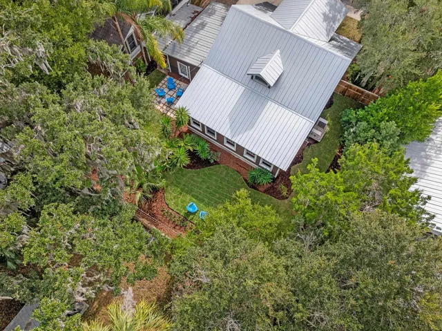 an aerial view of a house with a yard and garden