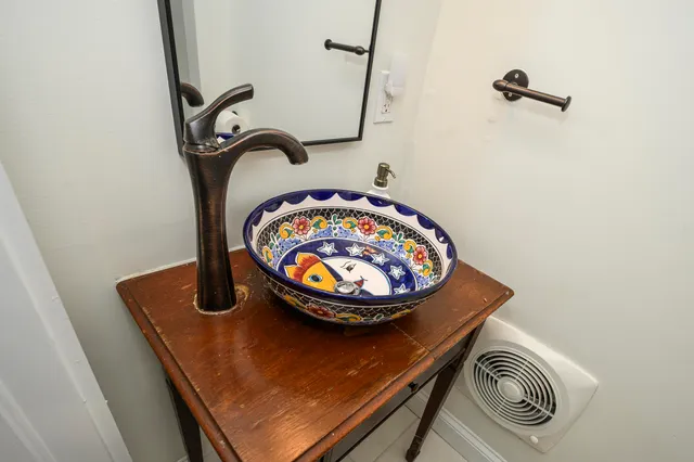 a living room with furniture potted plant floor to ceiling window and potted plant