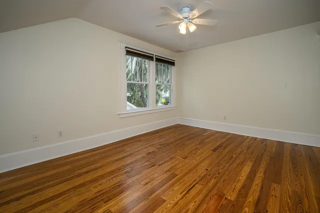 a view of a chair and table in backyard of the house