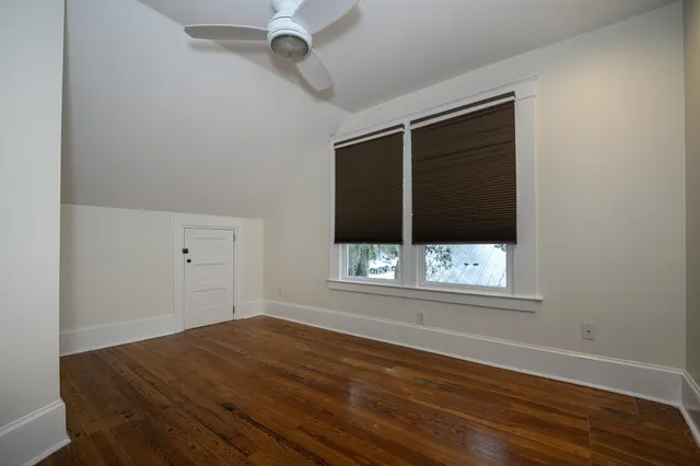 an aerial view of a houses with a yard