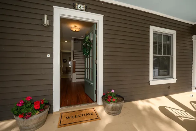 a hallway with a table and a potted plant