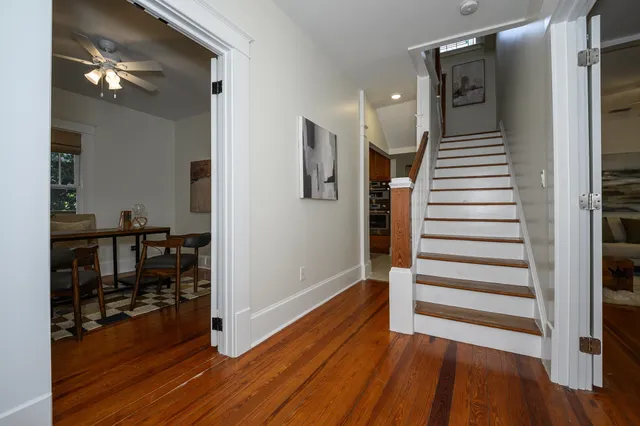 a view of a dining room with furniture and wooden floor