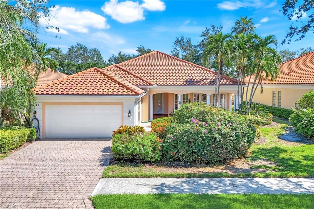 5129 Inagua Way Naples, FL 34119 - Photo 1 of 2 Mediterranean / spanish house featuring an attached garage, a tiled roof, stucco siding, and decorative driveway