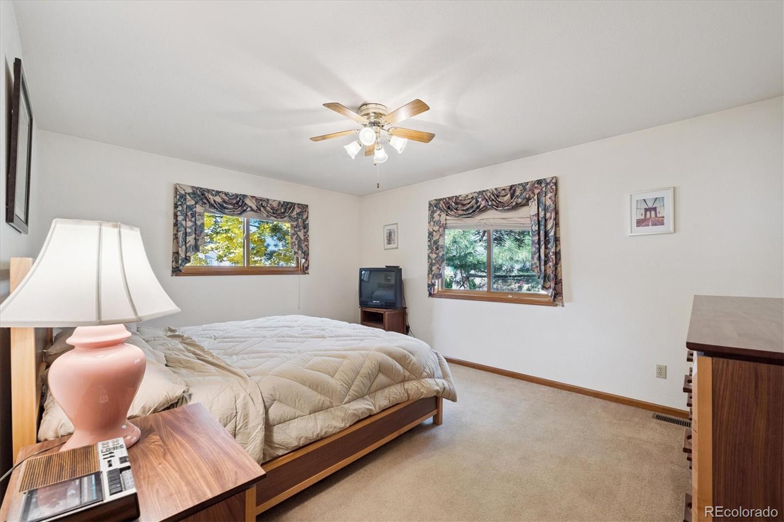 17537 59th Place Golden, CO 80403 - Photo 17 of 45 a bedroom with a bed and a painting on the wall