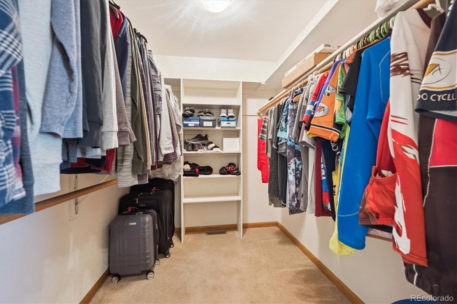 17537 59th Place Golden, CO 80403 - Photo 21 of 45 a view of walk in closet with clothes and shoes