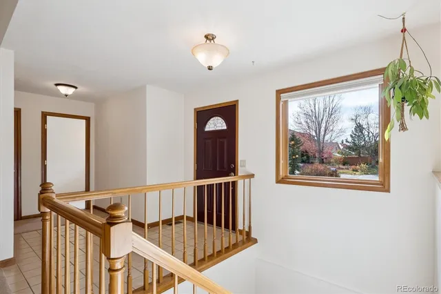 a view of staircase with railing and a chandelier