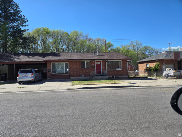 490 Averett Avenue, Unit 1 Springville, UT 84663 - Photo 1 of 11 Ranch-style house featuring an attached carport, brick siding, and driveway